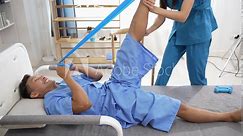 A nurse helps with physical therapy for a male patient at the hospital. Asian male patient receives treatment at medical relief clinic Health insurance concept