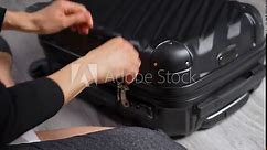 Suitcase Packing. Close-up of a woman hands closing suitcase. Ready for travel and vacations