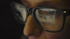 Cg footage. The glasses on the female face reflect the search for information on the Internet and symbols of digitalization of information flows