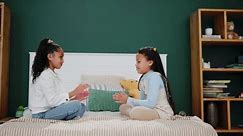 Children, learning and girl siblings on bed with hand game, fun and playful bonding in their home together. Family, love or kids with childhood palm match in bedroom with support, teaching or contest