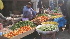 Rahim Yar khan-Pakistan 3rd may 2023: 4k footage of a seller selling Fresh vegetables in vegetables market. Seller displayed colorful vegetables in a stall. Many varieties of colorful vegetables.