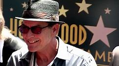 Charlie Sheen flashes a gold tooth on the Walk of Fame
