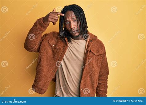 African American Man with Braids Wearing Brown Retro Jacket Pointing Unhappy To Pimple on ...