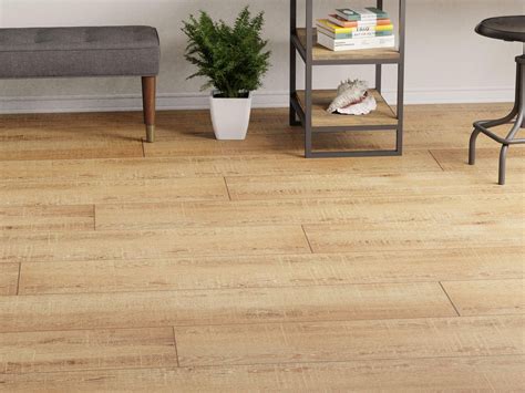 The 12 x 60 Montpellier Oak Wood Plank Porcelain Tile is brown with a ...