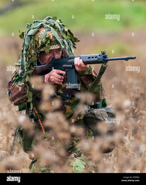1970 – 1980 British Army soldier in camouflage suit and steel helmet ...