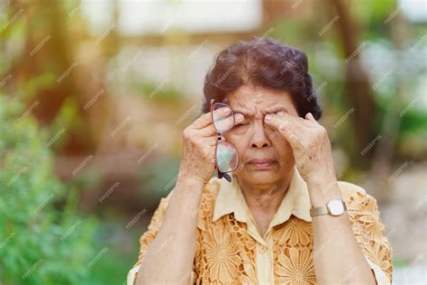 Premium Photo | Old thai woman massages eye sockets because of eye pain after using too much eyes