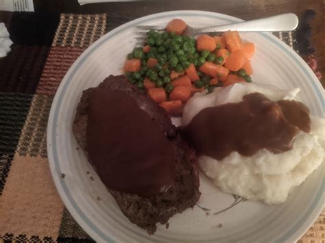 Classic Meatloaf dinner, with mashed potatoes, fresh peas and carrots ...