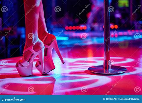 Young Woman Pole Dancing Striptease with Pylon in Night Club. Beautiful ...