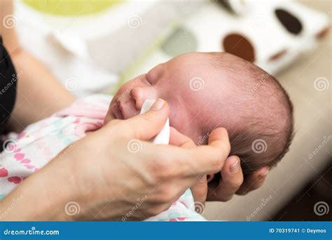 Mother Cleaning Nose Mucus Of Adorable Baby With A Nasal Aspirator ...