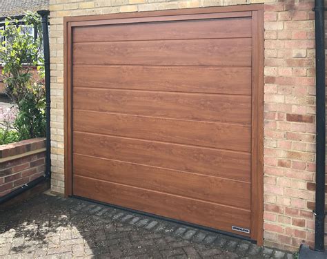 Hormann lpu42 m ribbed sectional garage door finished in golden oak ...