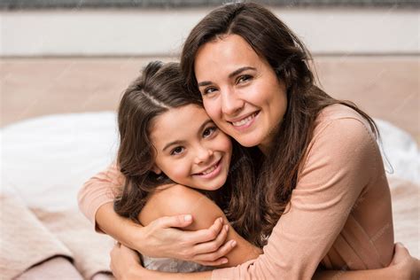 Premium Photo | Mother and daughter hugging home