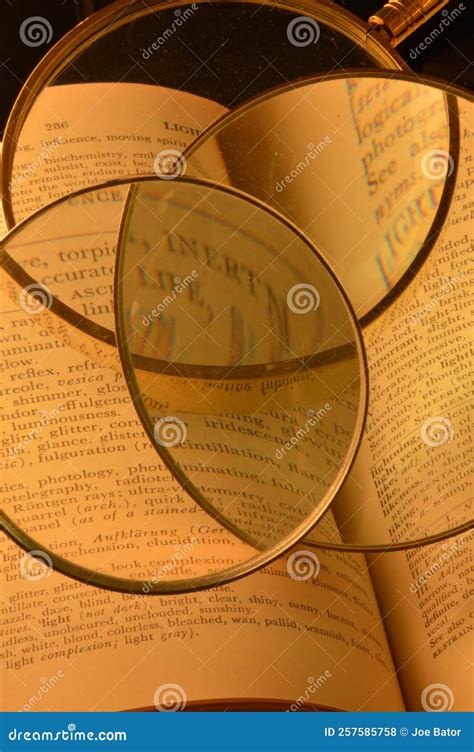 Three Magnifying Glasses and a Thesaurus Stock Photo - Image of ...