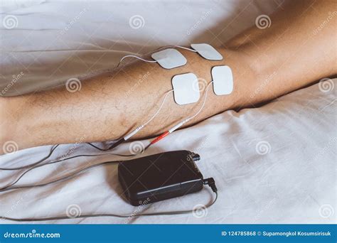 Patient Applying Electrical Stimulation Therapy On Knee Joint. T ...