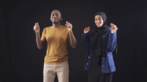 Cute african amateur dancers dancing on black background. Muslim black man and woman who grew up ...