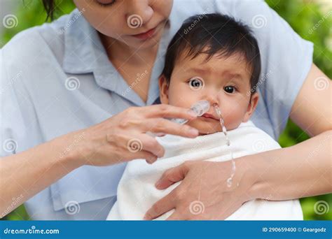 Mother Making Nasal Wash for Infant with Syringe and Saline. Cleaning ...