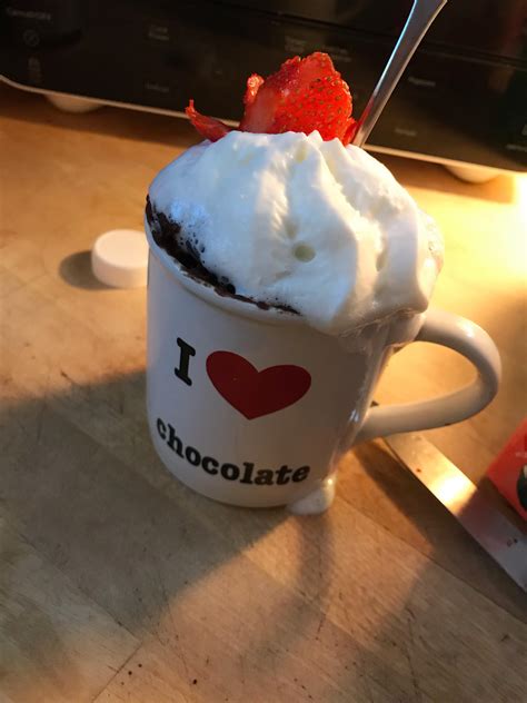 Whipped cream,two mug brownie mixes, and one strawberry cut to look ...