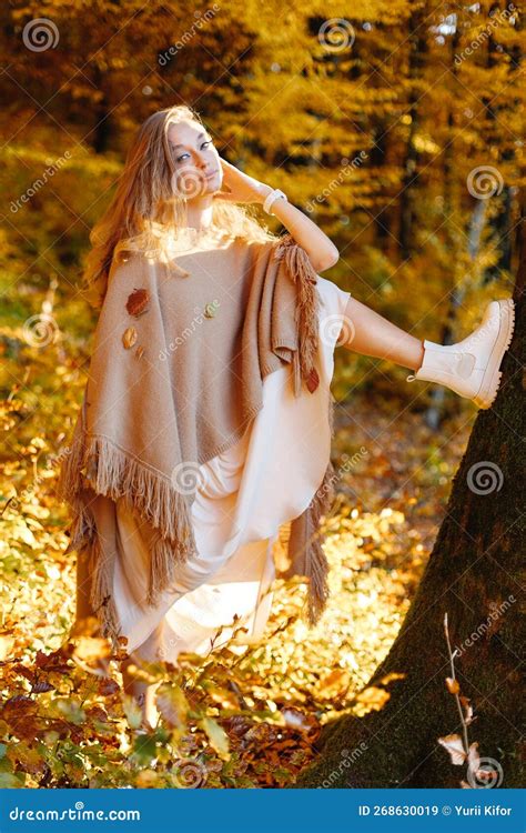 A Fantastic Woman in the Autumn Forest on the Background of Yellow Cast ...