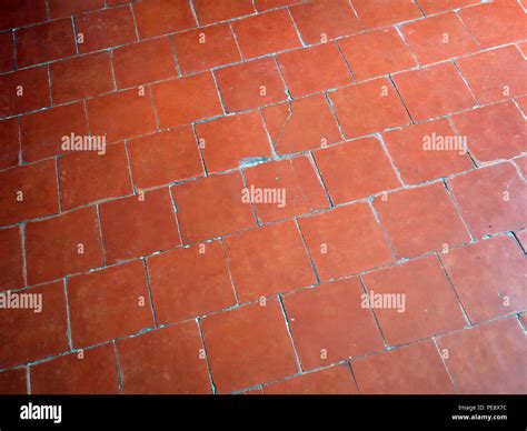 Red antique floor tiles in a large French house Stock Photo - Alamy