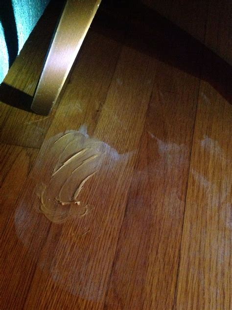 To remove fingernail polish remover stain on wood flooring... Rub ...