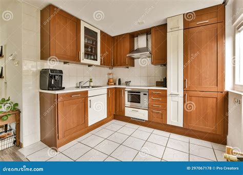 A Kitchen with Wooden Cabinets and a White Tile Floor Stock Photo ...