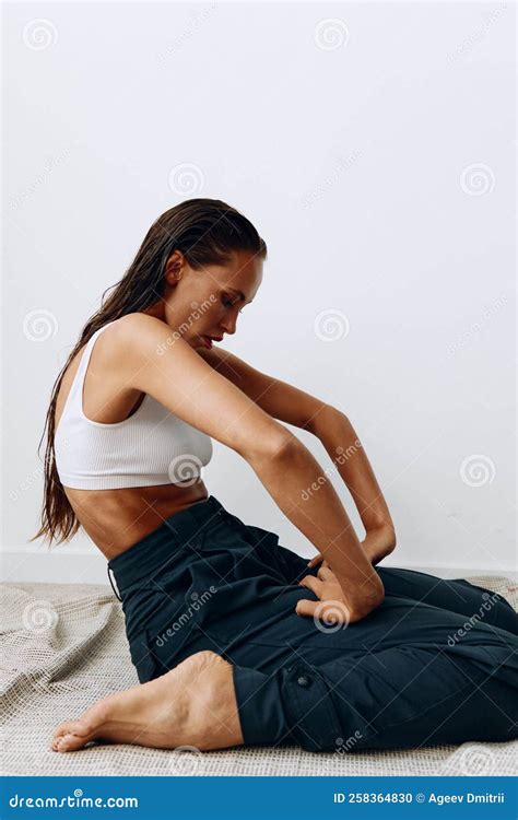 Woman Poses Sitting on Her Knees on the Floor with Beautiful Tanned ...
