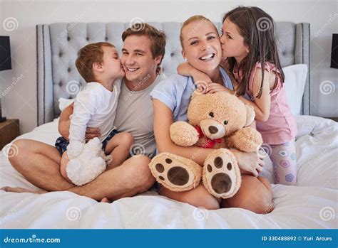 Happy, Family and Embrace with Kiss in Bedroom for Love, Bonding and ...