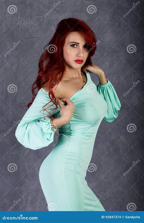 Portrait of Beautiful Redhead Young Woman with Big Boobs in a Turquoise ...
