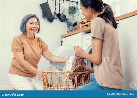Contented Daughter and Mother in the Household Washing Room Working Together. Stock Photo ...