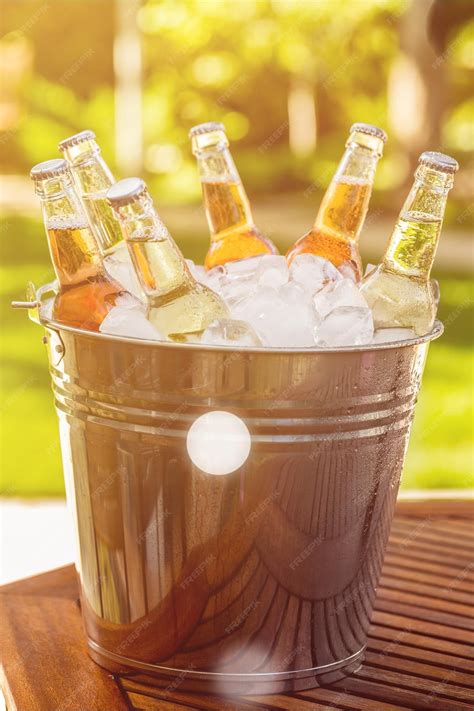 Premium Photo | Bottles of cold and fresh beer with ice isolated