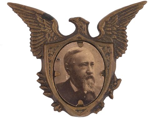 Hake's - HARRISON EAGLE MOTIF BRASS SHELL BADGE.