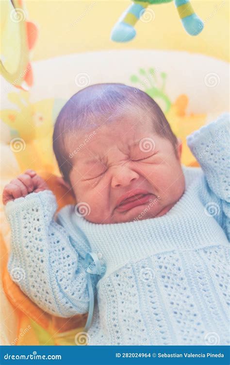 Newborn Sneezing and Sitting in a Rocking Chair Stock Photo - Image of ...