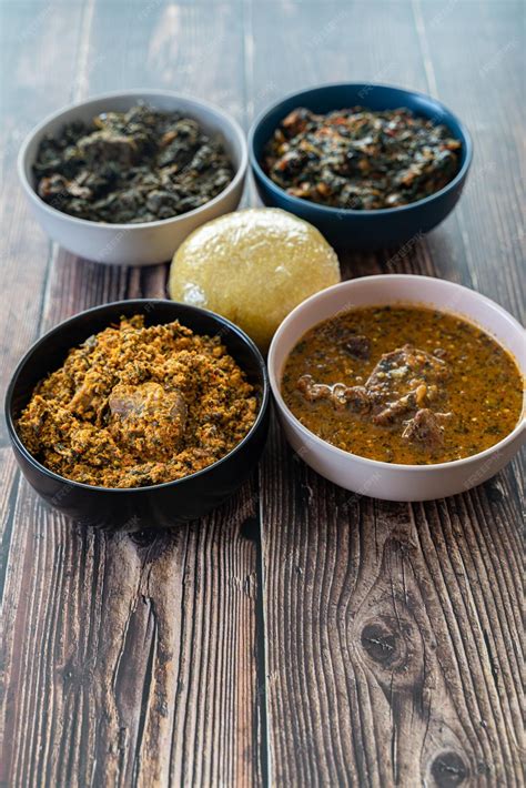 Premium Photo | Egusi ogbonno vegetable and afang soup with pounded yam and eba garri