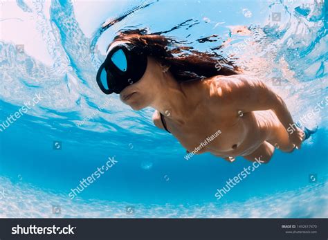 Стоковая фотография 1492617470: Naked Woman Free Diver Glides Over ...