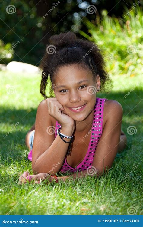 Young Black Teenage Girl Lying On The Grass Royalty Free Stock ...