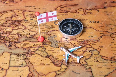 Premium Photo | Flag of georgia compass and plane on the world map