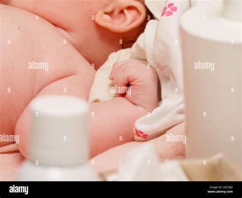Close-up of newborn arm and clenched fist during baby thalassotherapy ...