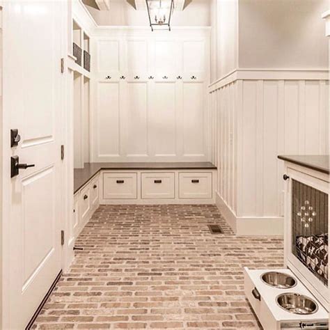Mud Room with Brick Floors and White Cabinets