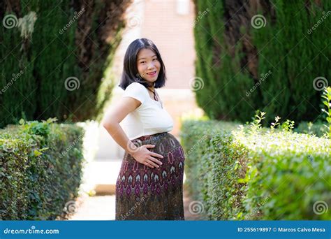 Young Happy and Beautiful Asian Japanese Woman Posing Outdoors Happy and Cheerful at City Park ...