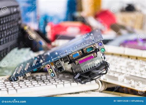 Spare Video Card on Pile of Computer Keyboards and Colored Hardware ...