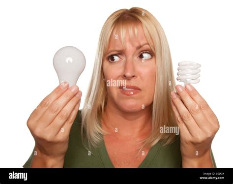 Expressive Woman Comparing Energy Saving and Regular Light Bulbs ...