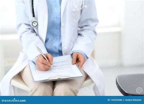 Female Doctor Writing Up Medication History Records Form on Clipboard ...
