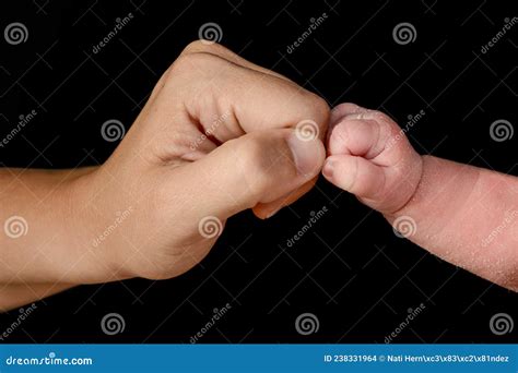 Small Closed Hand of Newborn Baby Bumping His Fist with His Mother`s ...