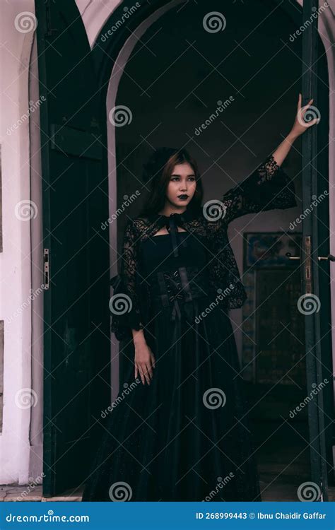 A Goth Asian Woman Dresses Up with Black Make Up and Wears Black Clothes Like a Scary Woman at ...