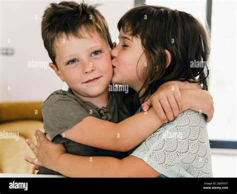 Twin brother and sister kissing hi-res stock photography and images - Alamy