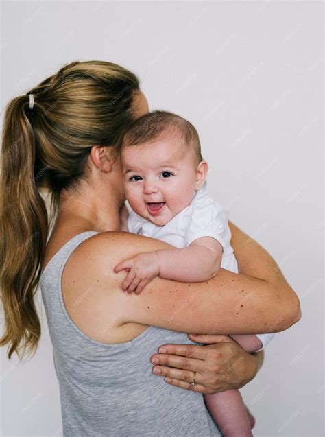 Premium Photo | A woman cradling a child holding a baby girl on her ...