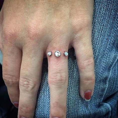 People Are Getting Diamond Dermal Piercings on Their Fingers in Place ...