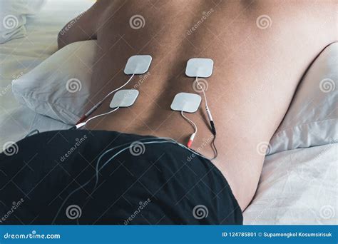 Patient Applying Electrical Stimulation Therapy on Back. Electrical ...