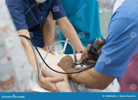 A Team of Urologist Doctors Performing a Cystoscopy Using a Cystoscope. in a Sterile Operating ...