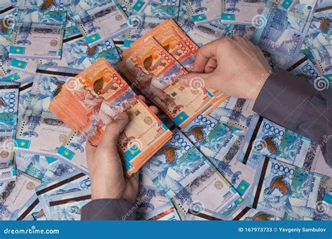 Hands Count Kazakhstan Money Tenge. Paper Banknotes Tenge KZT. Tenge is the National Currency of ...