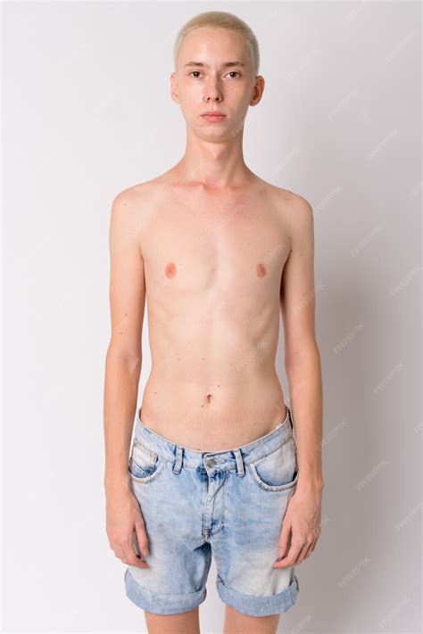 Premium Photo | Young handsome androgynous man shirtless against white wall